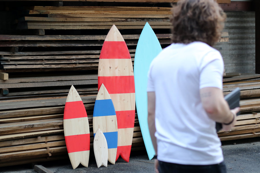 Three friends, decorative surfboards and a blueprint for the planet.